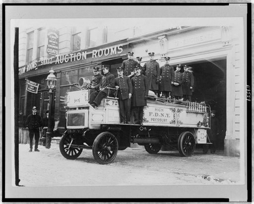 Firemen posed on fire engine, New York City
