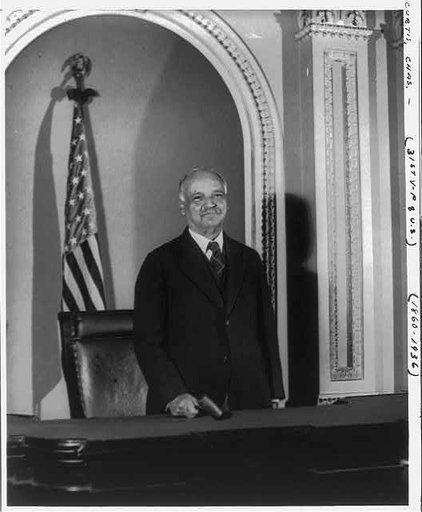 Charles Curtis, 31st vice president, half-length portrait, facing front, standing on the Senate rostrum in the U.S. Capitol