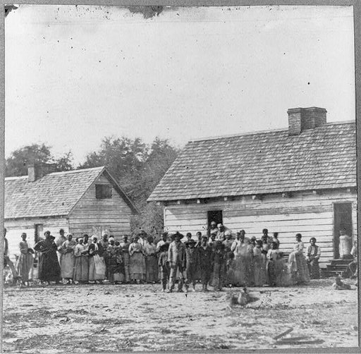 Large group of slaves(?) standing in front of buildings on Smith's Plantation, Beaufort, South Carolina