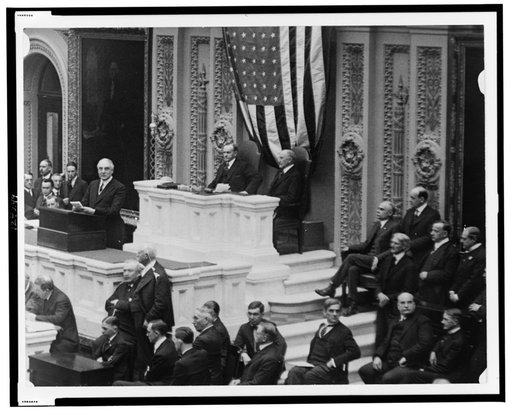A session in the House of Representatives, with Warren Harding speaking, and Calvin Coolidge and Frederick Gillett seated behind desk
