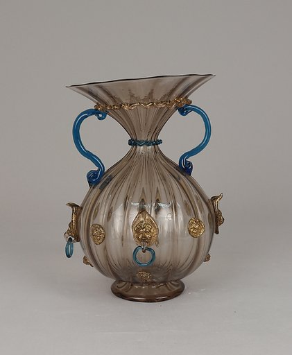 Ribbed and fluted vase with lion masks