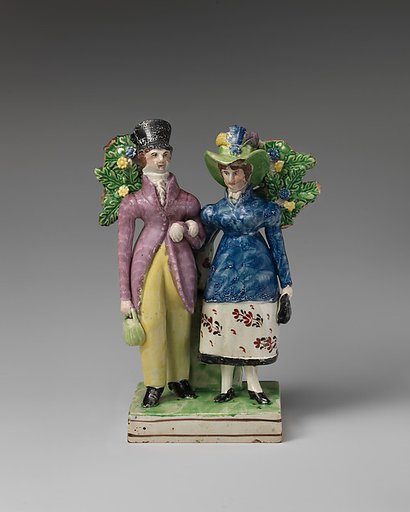 Man and woman standing near a tree
