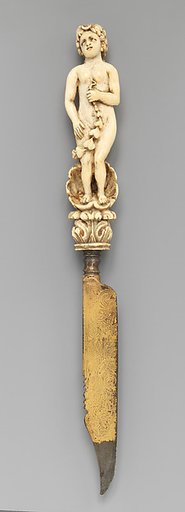 Knife with carved handle of nude female with crescent in hair standing in a half shell holding a swag