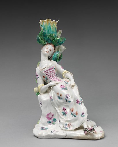 Candlestick in the form of a female dozing figure (one of a pair)