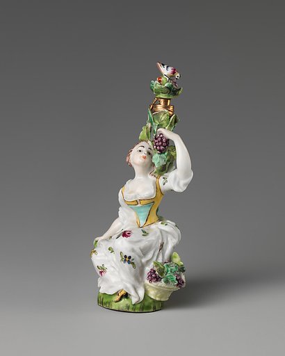 Lady seated amongst a grapevine