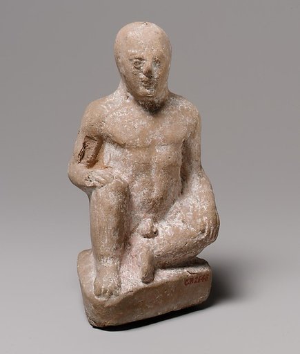 Terracotta statuette of a seated boy