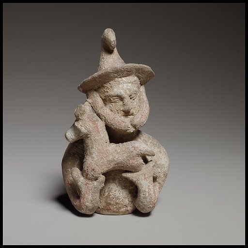 Terracotta statuette of a male votary offering a kid