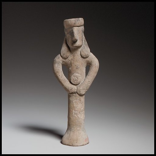 Standing figure holding a tambourine(?)