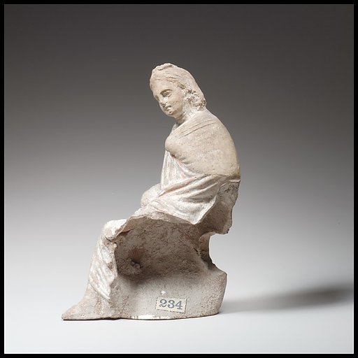 Terracotta statuette of a seated youth