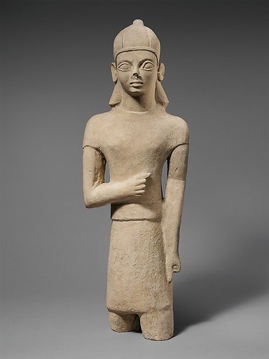 Limestone votary of a bearded male in Egyptianizing dress