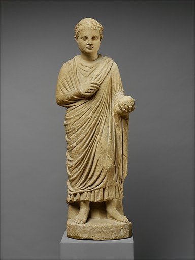 Limestone statue of a wreathed boy holding a ball or piece of fruit