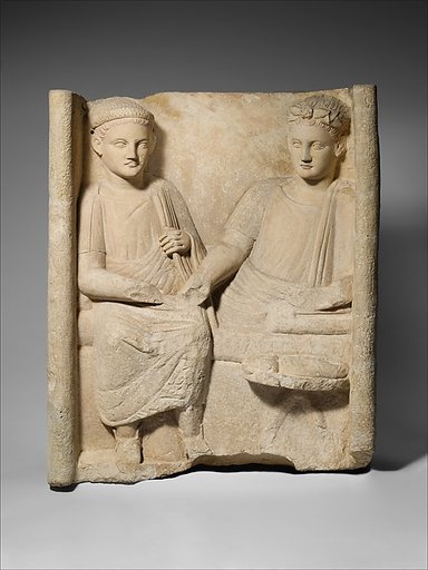 Limestone funerary stele with banquet scene