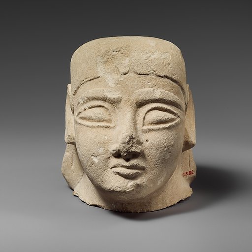 Limestone head of a beardless male with a plain headdress