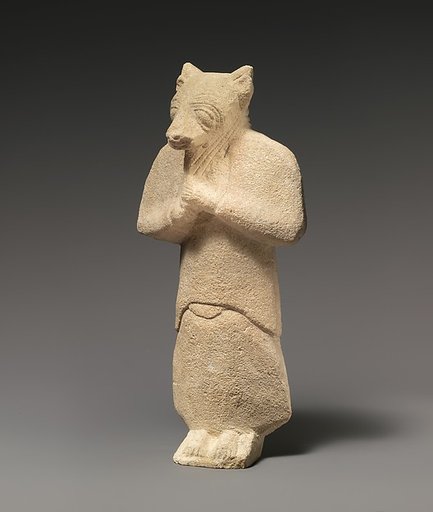Limestone figure wearing a mask