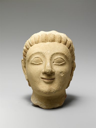 Limestone head of a beardless man