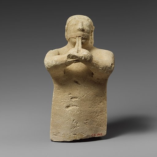 Limestone statuette of a male aulos player