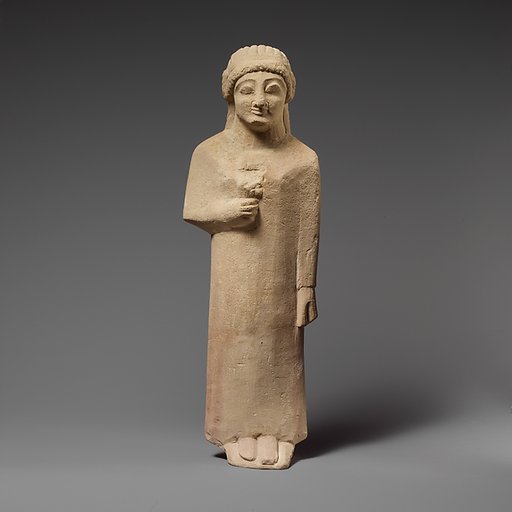 Limestone statuette of a female votary holding a flower