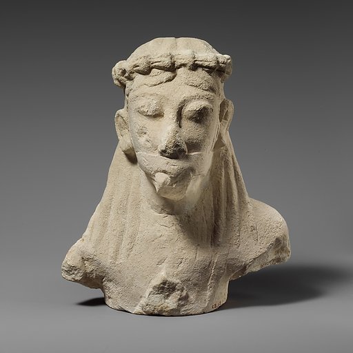 Upper part of a limestone statuette of a male aulos player