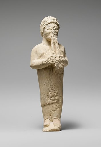 Limestone statuette of a flute-player