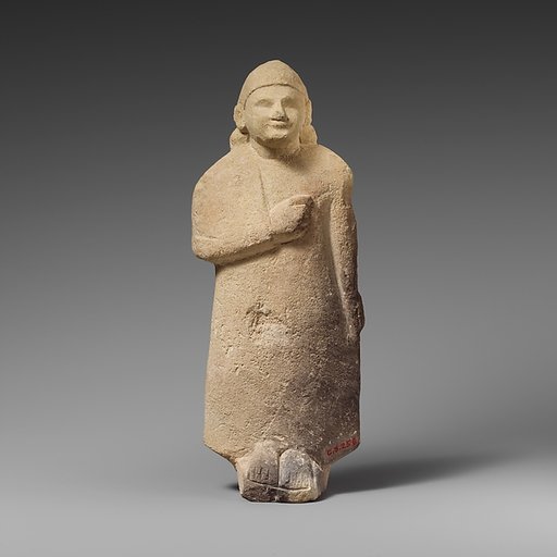 Limestone statuette of a beardless male votary with a conical helmet