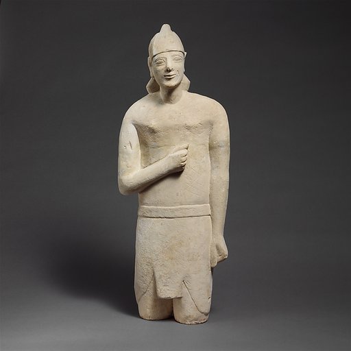Limestone statuette of a beardless male votary in Egyptianizing dress wearing a helmet
