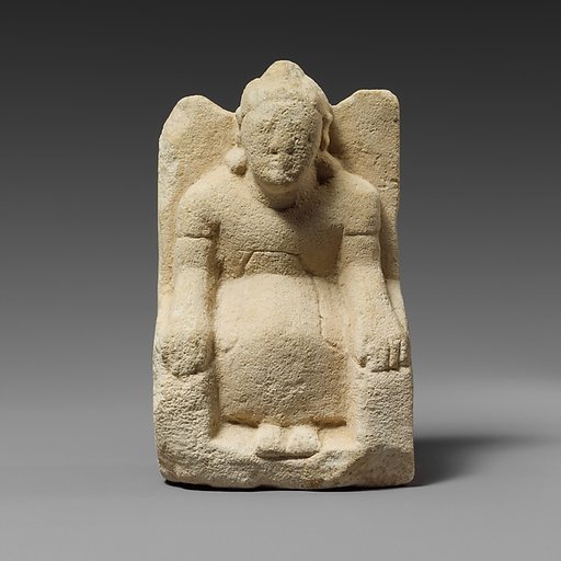 Limestone statuette of a seated beardless male votary with a helmet