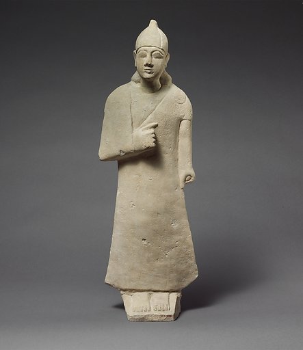 Statuette of a beardless male votary wearing a long garment and a conical helmet