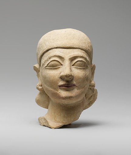Limestone head of a man with a plain headdress