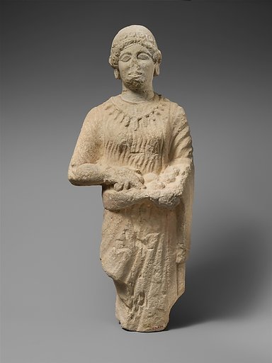 Limestone statuette of a female votary holding pieces of fruit