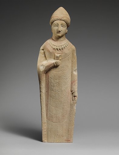 Limestone statuette of a female votary holding a flower