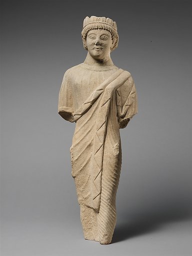 Limestone statuette of a beardless male votary in Greek dress with a wreath of leaves