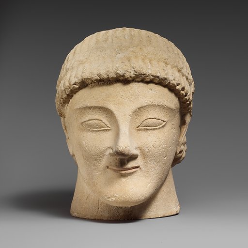 Limestone head of a beardless male votary with a wreath of rosettes