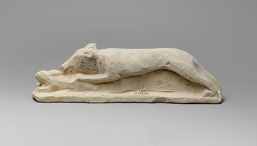 Limestone votive statuette of a hound seizing a hare