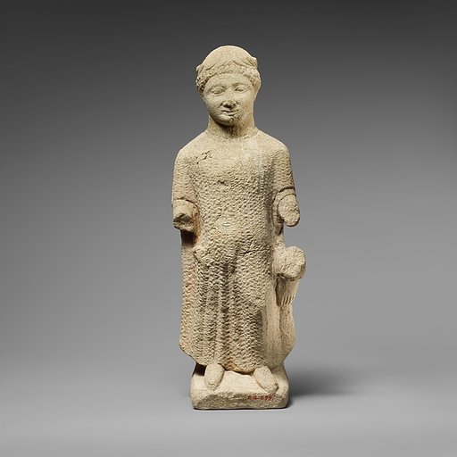 Limestone statuette of a boy holding a bird