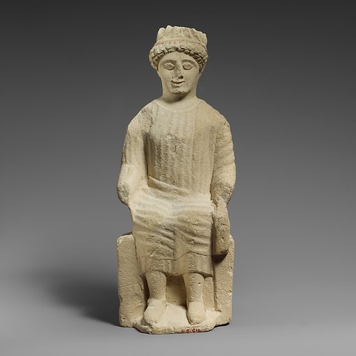 Limestone statuette of a seated beardless male votary