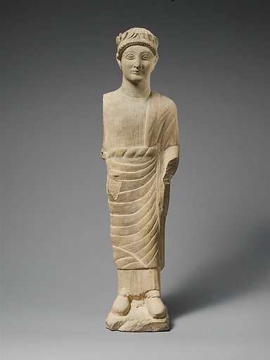 Limestone statuette of a beardless male votary with a wreath of leaves