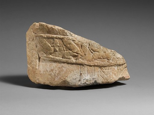 Fragment of an male limestone votary with an Egyptianizing kilt
