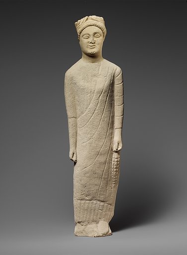 Limestone statuette of a beardless male votary with a wreath of leaves