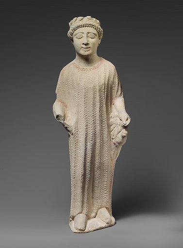 Limestone statuette of a boy holding a dove