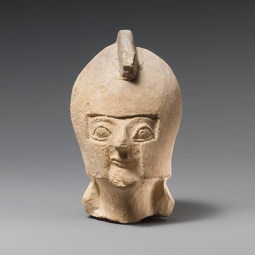 Limestone head of a warrior wearing a crested helmet