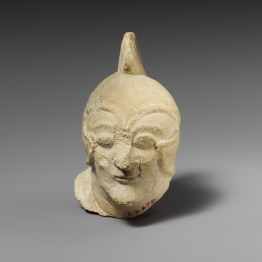 Limestone head of a beardless male with a helmet of Greek type