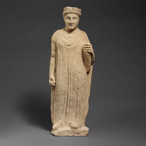 Limestone statuette of a boy holding a bird