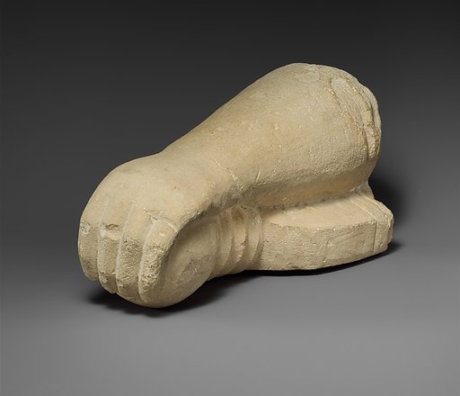 Limestone arm holding a sword