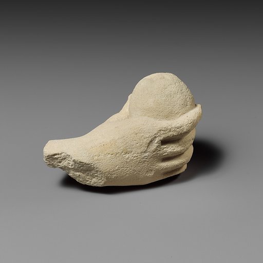 Limestone hand holding a piece of fruit