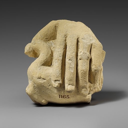 Limestone hand holding a bird