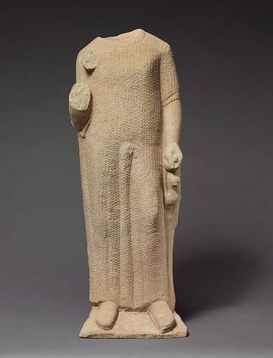 Limestone statuette of a boy holding a dove
