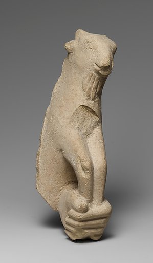 Limestone statue fragment of a left hand holding a kid