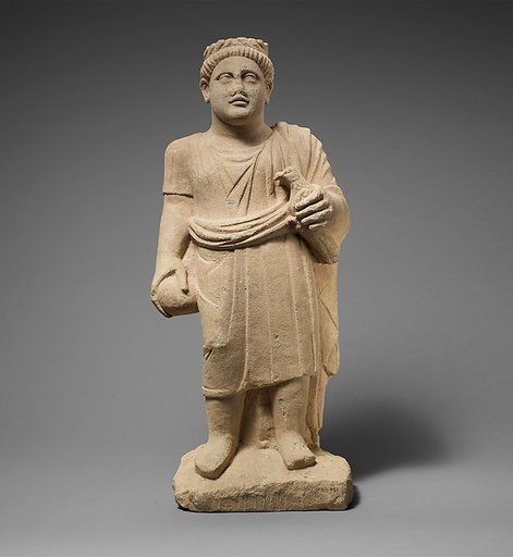 Limestone statuette of a boy with a wreath of leaves