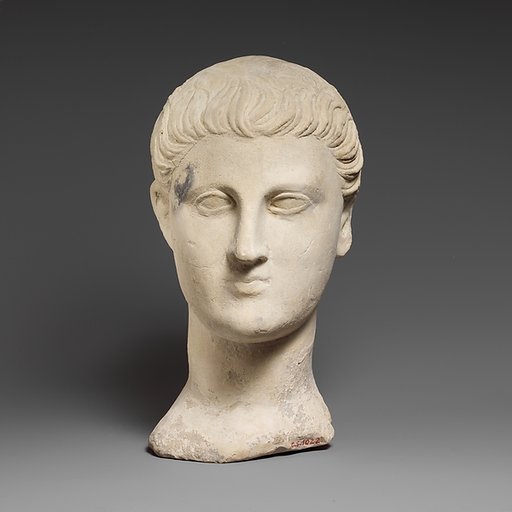 Limestone funerary bust of a beardless man