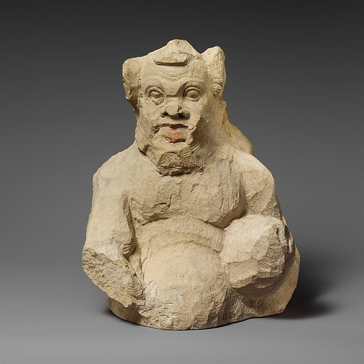 Fragment of a partly unfinished limestone statuette of a silen